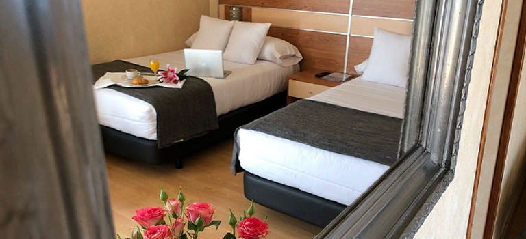 Two beds in a hotel room