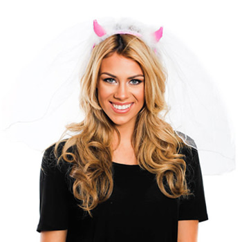 A model wearing a pair of pink devil horns with a white veil