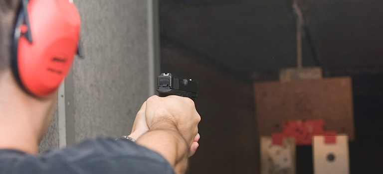 A man aiming a gun