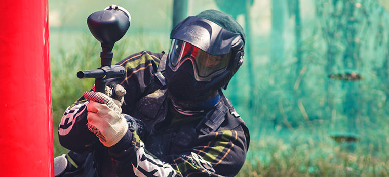 A man playing paintball outdoors