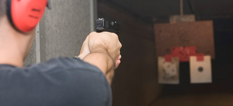 A man aiming a gun at a target
