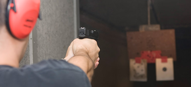 A man aiming at a target at a shooting range