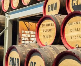 Stacks of wooden barrels with information on relating to the production of Guinness