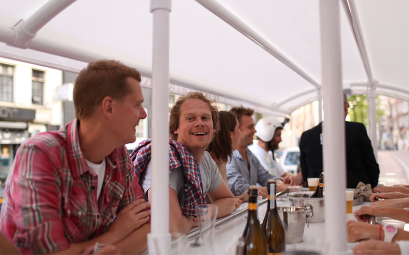 Some men on a beer bike in Amsterdam