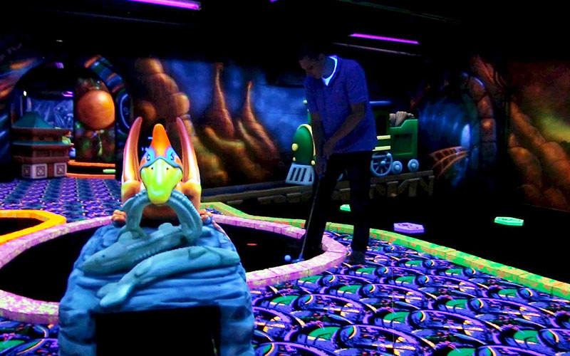 A man playing glow golf in Amsterdam