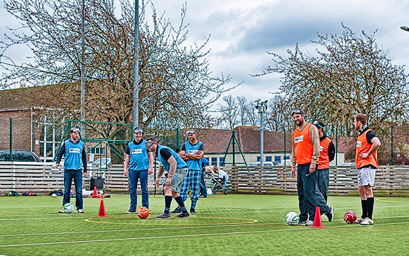 Some stags playing goggle football on astroturf