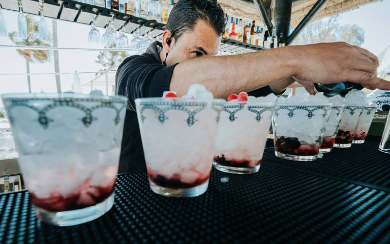 A barman pouring drinks at the bar