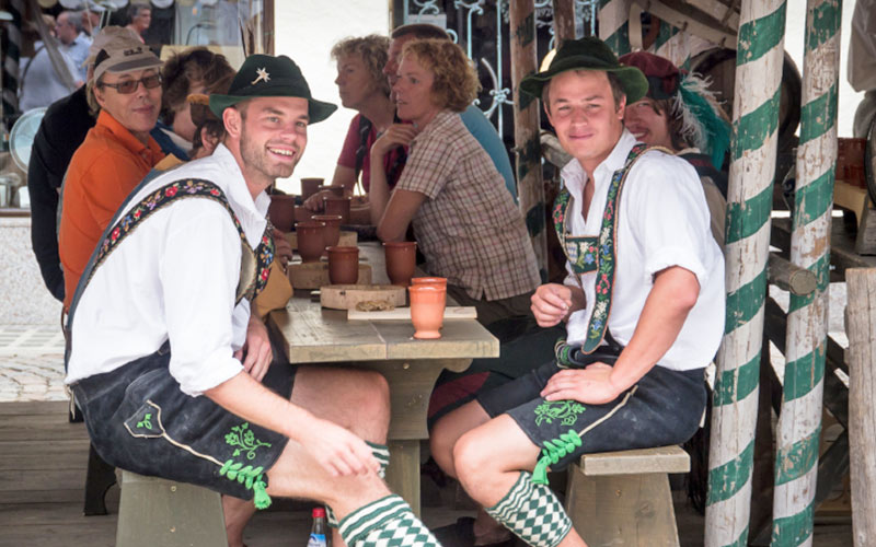 Two men wearing lederhosen and Bavarian clothing