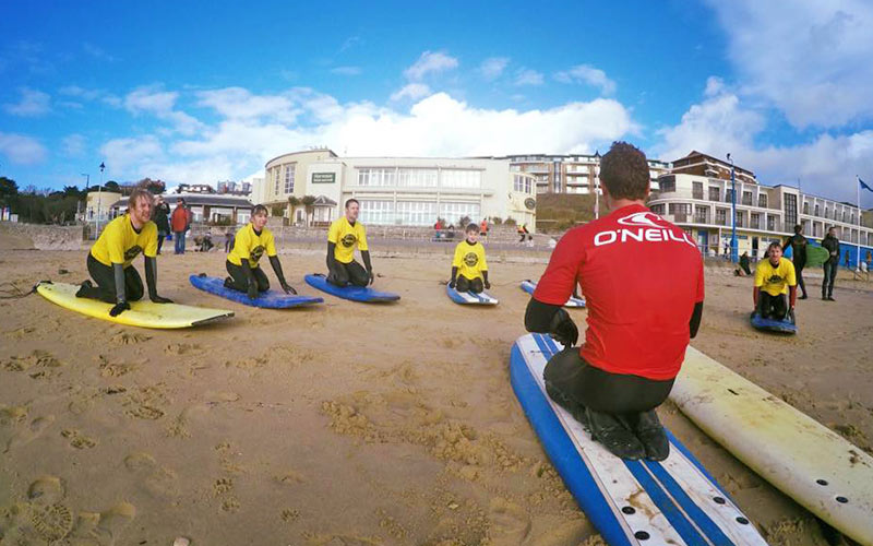 Some men having a surf lesson in Bournemouth
