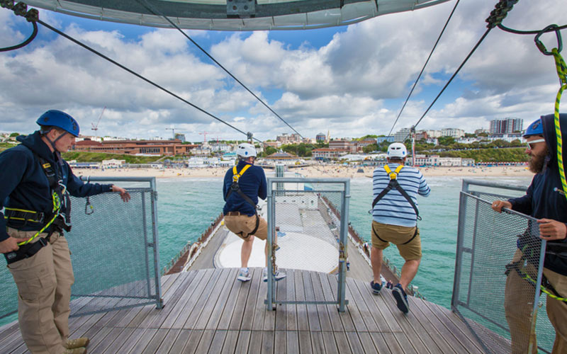 Some men jumping off into the water in Bournemouth