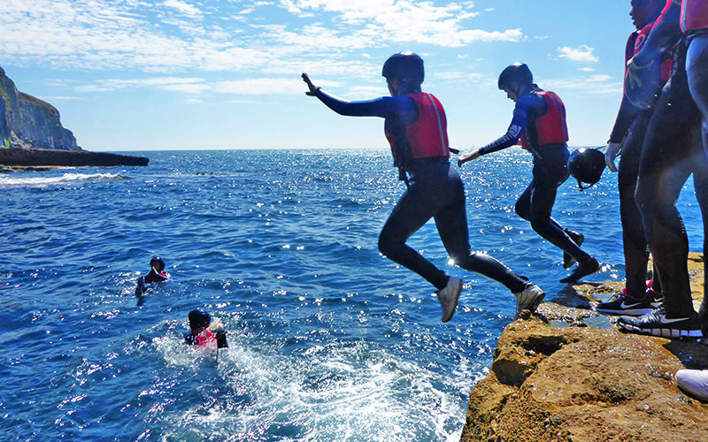 Some people jumping into the water in Bournemouth