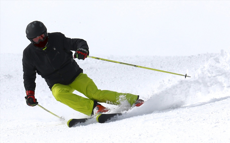 A man skiing on the slopes