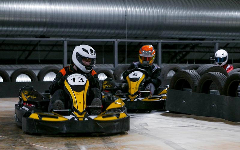 Some men racing go karts