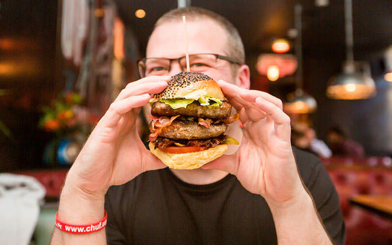 A man with a burger in his hands