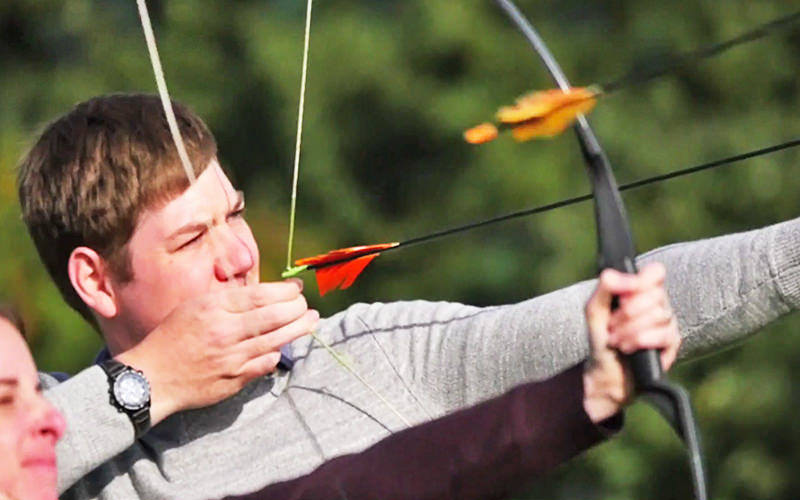 A man firing a bow and arrow