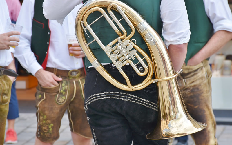 A German band carrying brass instruments
