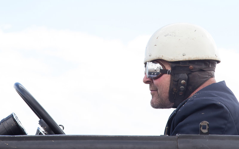 A man wearing a helmet, in a car
