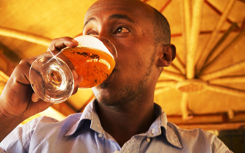 A man holding a beer to his lips