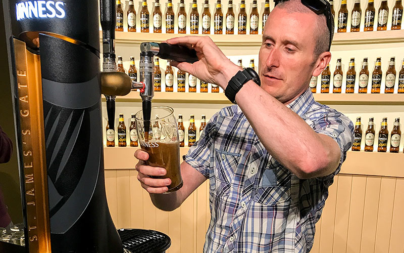 A man pulling his own pint of Guinness in the Guinness Storehouse, Dublin