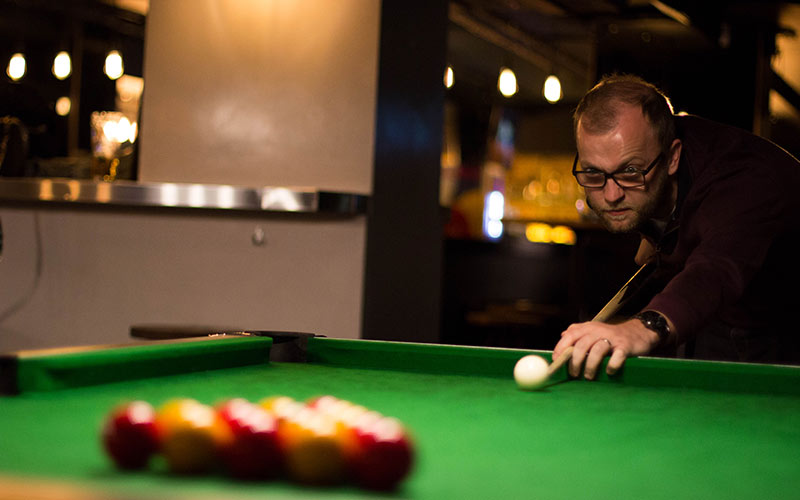 A man playing pool in Buskers on the Ball, Dublin