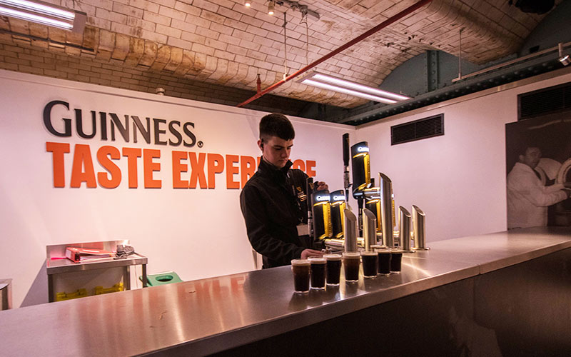 A man behind the bar in the Guinness Factory 