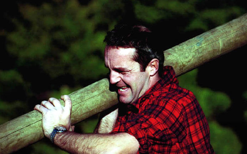 A man carrying a log