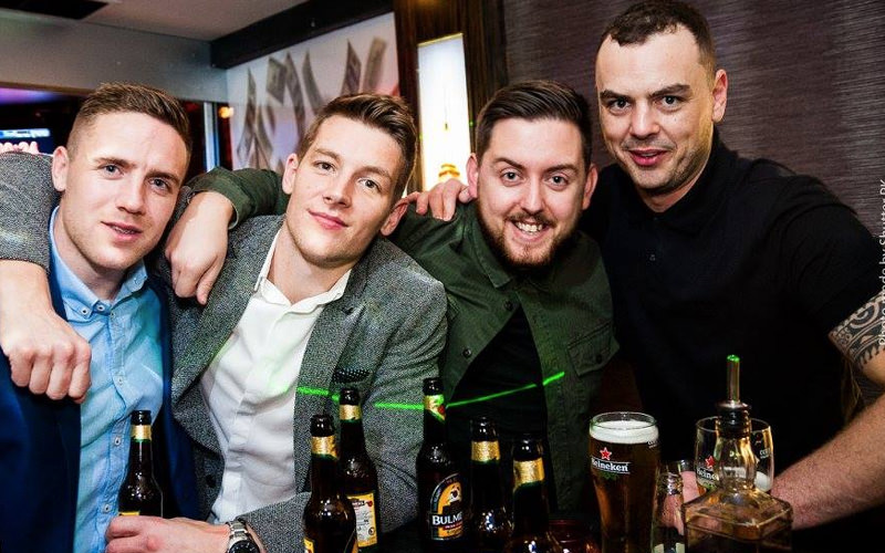 Four men with beers in a pub