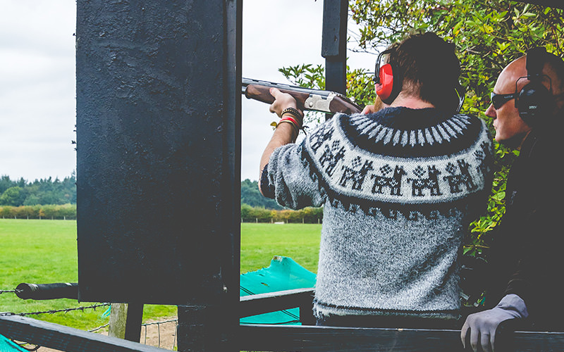 A man firing a gun in a shooting range