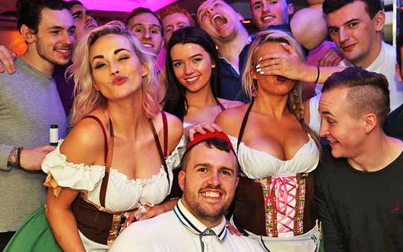 A group of stags with the Bavarian beermaids