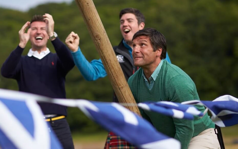 Three men playing the highland games