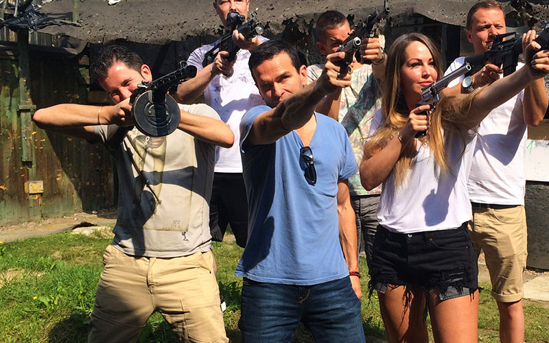 A group of men and one girl holding guns in Krakow