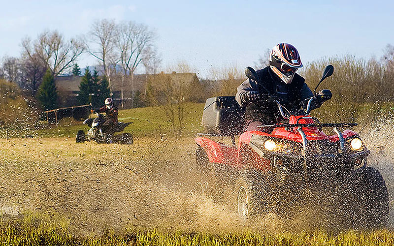 Some men on quad bikes trailing through water