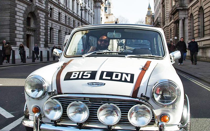 A Mini Cooper being driven through London city centre