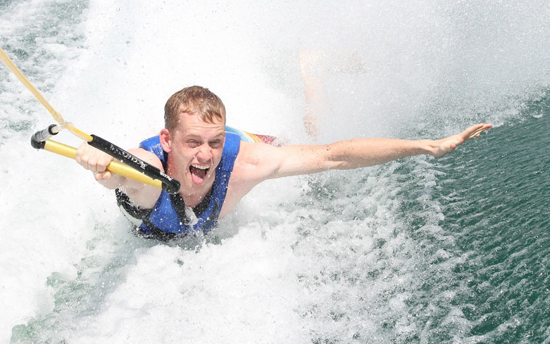 A man being pulled along the water by a rope