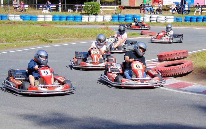 Some men driving around in go karts