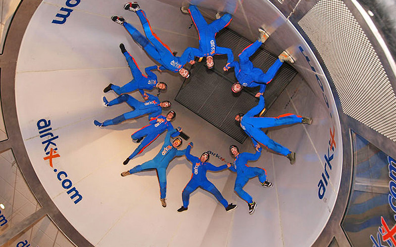 Some people in a skydiving simulator