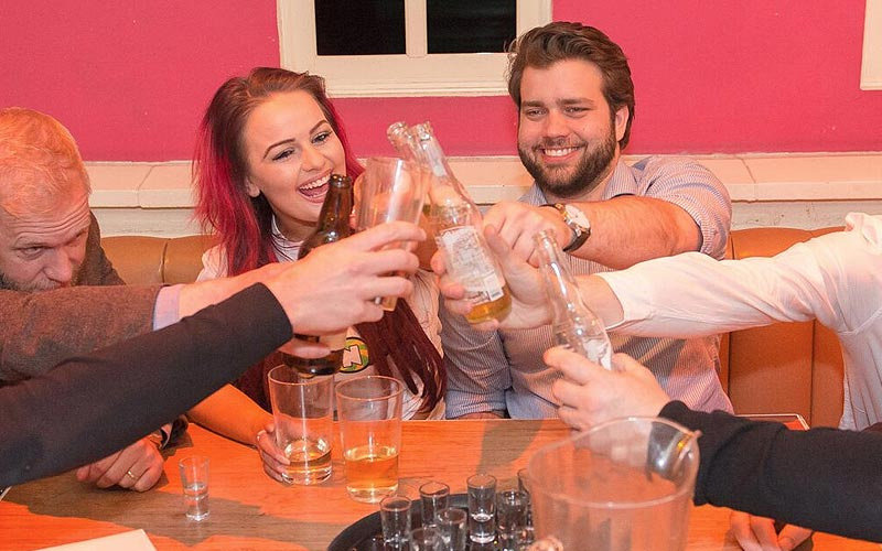 A group of people sitting around a table with drinks