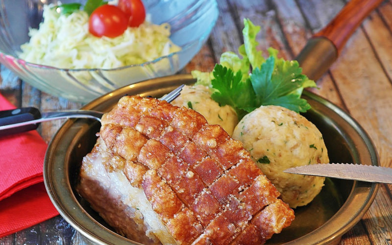 A pan of food with a dressing behind
