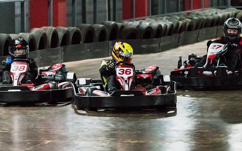 Some men driving in go karts