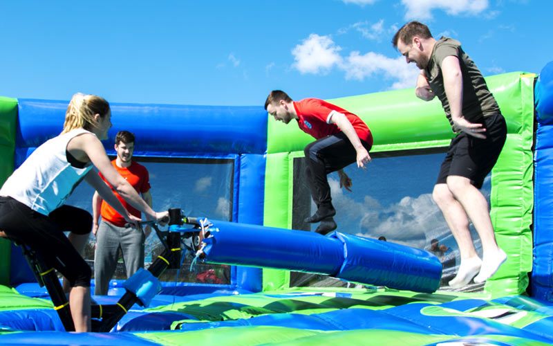 People jumping over an inflatable obstacle at the Geordie Games