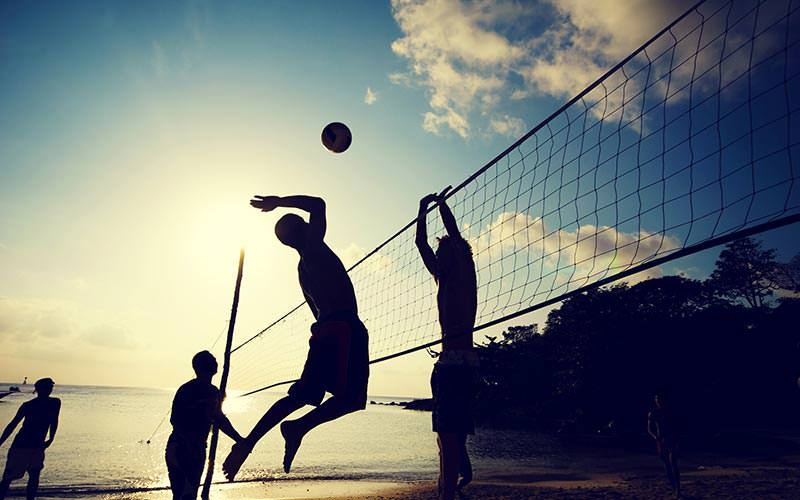 Some silhouettes of people playing beach volleyball in Newquay