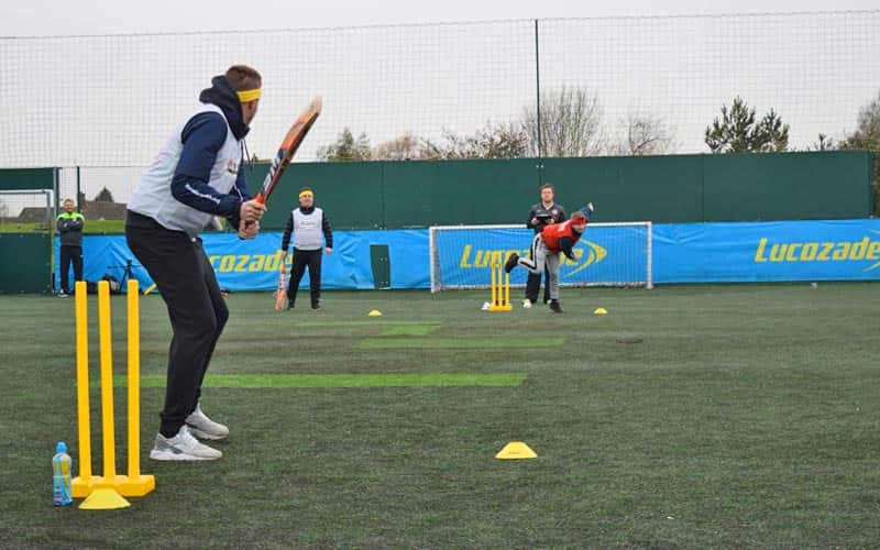 Some men playing quick cricket on AstroTurf
