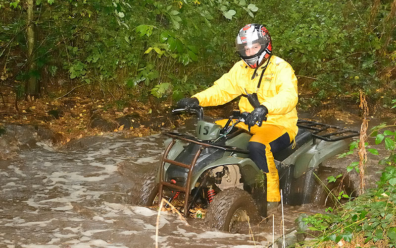 A man on a quad bike in the mud