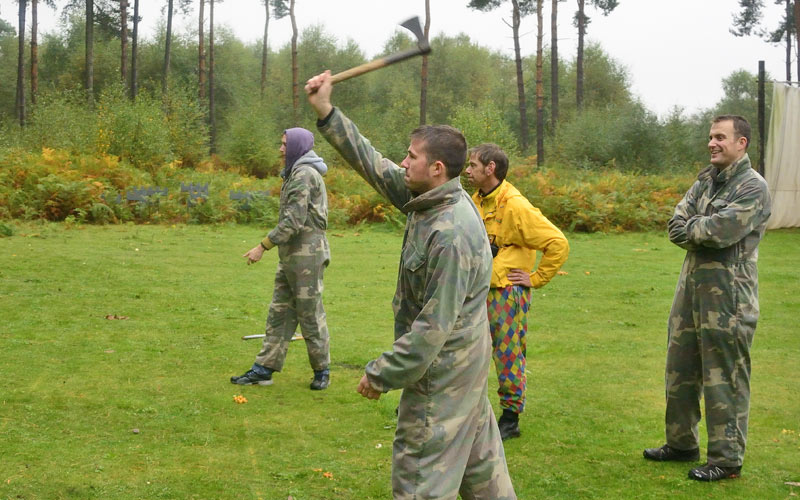 A group of men with one throwing an axe