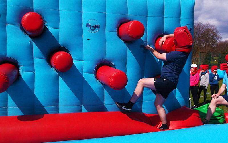 Someone on an inflatable obstacle
