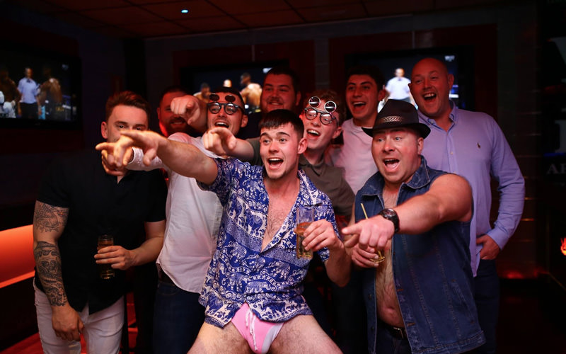 A group of men pointing and laughing