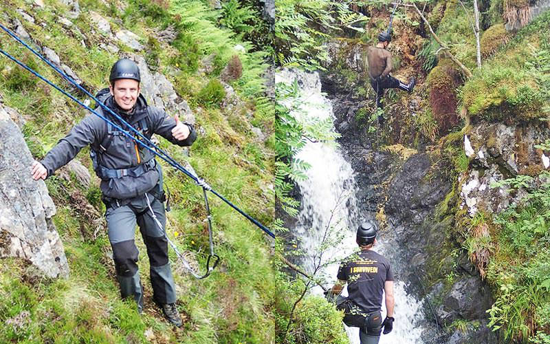 Two men on a cliff, with ropes attached to them
