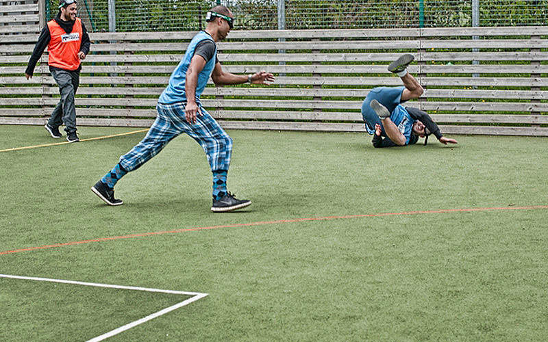 A group of men wearing head gear on a pitch