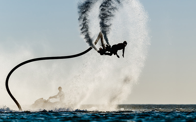 A man on a flyboard above the sea