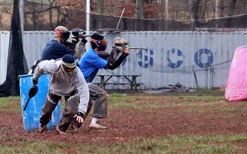 A group of people carrying paintball guns